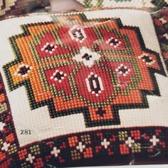 a close up of a cross stitch pattern on a pillow