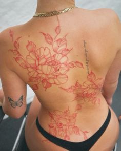 the back of a woman's body with flowers on it