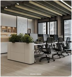 an office with desks, chairs and planter in the middle of the room