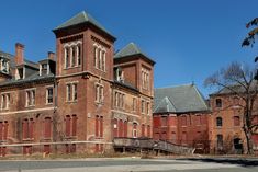 an old red brick building with two towers