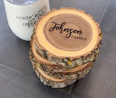 a stack of logs sitting next to a white coffee mug