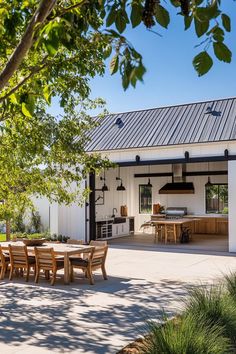 an outdoor kitchen and dining area is shown in this photo, with the patio visible