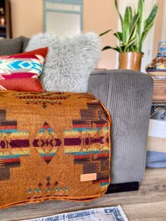 a living room filled with furniture and pillows