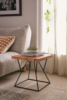 a living room scene with focus on the sofa and coffee table in the foreground