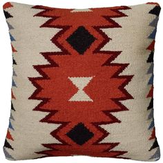 a red, white and black pillow with an arrow design on the front end is shown