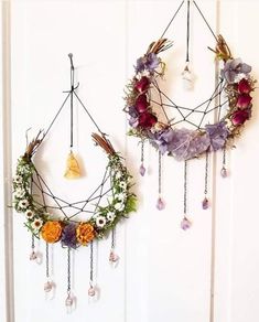 two wreaths hanging from the side of a door with beads and flowers on them