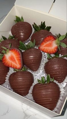 chocolate covered strawberries in a box on a table