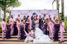 the wedding party is posing for a photo on the steps in front of a large painting