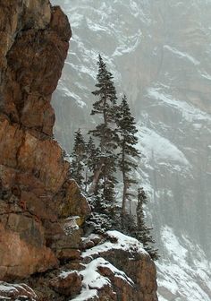 a man standing on top of a snow covered mountain