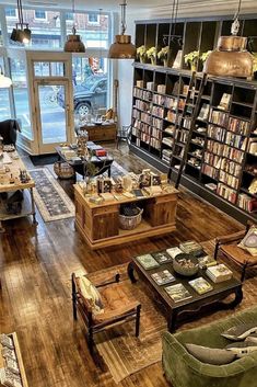 a living room filled with lots of furniture and bookshelves next to a window