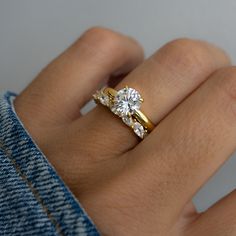 a woman's hand with a diamond ring on it