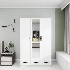 a bedroom with white furniture and green walls