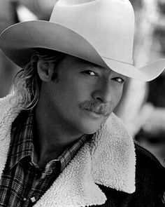 a man wearing a cowboy hat and jacket