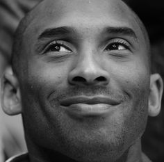 a black and white photo of a man with his eyes wide open looking into the camera