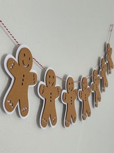 some cut out gingers are hanging on a string