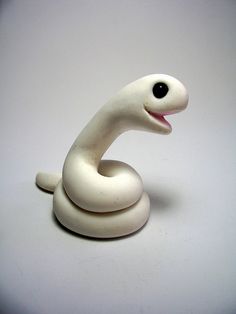 a white ceramic figurine sitting on top of a table