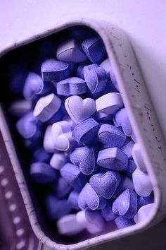 purple and white candies in a metal container