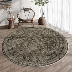 a round rug with an ornate design on the floor next to a chair and potted plant