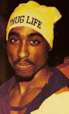 a man wearing a yellow hat with the words dope life on it's side