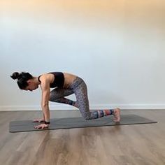 a woman is doing yoga on a mat