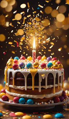 a birthday cake with a lit candle surrounded by confetti and sprinkles