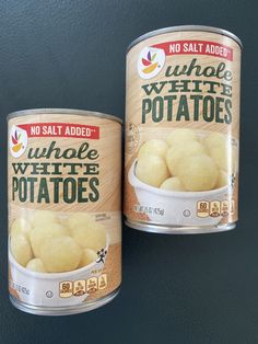 two canisters of whole white potatoes sitting side by side