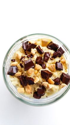 a glass bowl filled with food on top of a white table