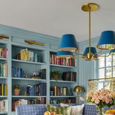 a living room filled with furniture and bookshelves covered in lots of bookcases