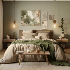 a bedroom with a bed, table and pictures on the wall above it in neutral colors