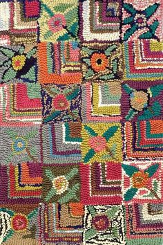 a multicolored rug with squares and flowers on it