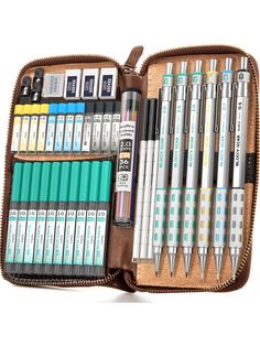 a brown case filled with lots of different types of pens and pencils next to each other