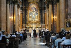 a bride and groom are standing in front of the alter