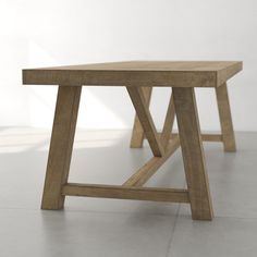 a wooden table sitting on top of a white floor