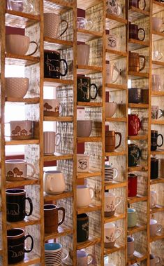 a display case filled with lots of different types of coffee mugs and saucers