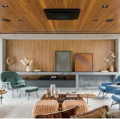 a living room filled with lots of furniture and walls covered in wooden slatted panels