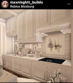 an image of a kitchen setting with white cabinets and flowers in vases on the counter