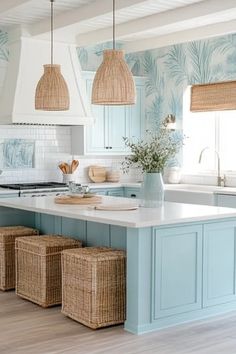 a kitchen with blue cabinets and wicker baskets hanging from the ceiling over the island