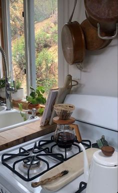 a stove top oven sitting inside of a kitchen next to a sink and countertop