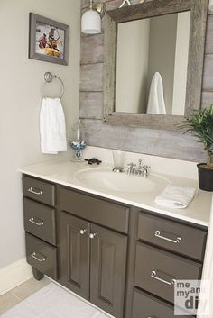 a bathroom with a sink, mirror and towel rack