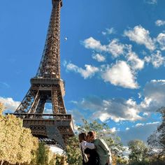 two people standing in front of the eiffel tower