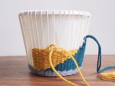 a close up of a yarn bag on a table with a string attached to it