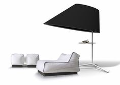 a white and black chair sitting next to a lamp