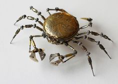 a gold colored clock sitting on top of a spider