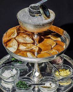 three tiered platter filled with food and condiments on top of each other