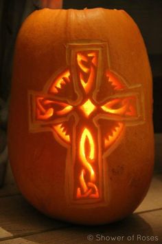 a carved pumpkin with a cross on it