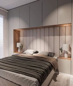 a large bed sitting next to a window in a room with wooden headboard and white walls