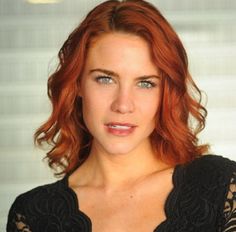 a woman with red hair and blue eyes