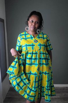 This roomy African print cotton summer dress will be one of your favorites this summer.  Fit: Relaxed Details:  - Dropped armholes - one button back closure - In seam side pockets Garments Measurements: MEDIUM Bust: 46 in Waist:  46 in Hips:  FREE Sleeve Length: 9 in Full Length: 42 in LARGE Bust: 48 in Waist:  48 in Hips:  FREE Sleeve Length: 9 in Full Length: 42 in READY TO SHIP IN 5 DAYS Machine Washable (cold with like colors suggested) and Dryer Safe  Hand wash is better to preserve the bri Cotton Short Sleeve Sundress, Multicolor Cotton Sundress With Short Sleeves, Yellow Cotton Knee-length Sundress, Yellow Cotton Midi Dress With Short Sleeves, Yellow Cotton Sundress With Short Sleeves, Yellow Cotton V-neck Sundress, African Print Dress Ankara, Best African Dresses, African Dresses Modern