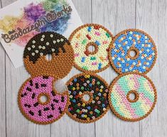 sequin donuts with sprinkles on them sitting next to a card