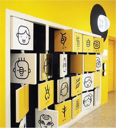 a yellow and black wall with many different types of stickers on it's sides